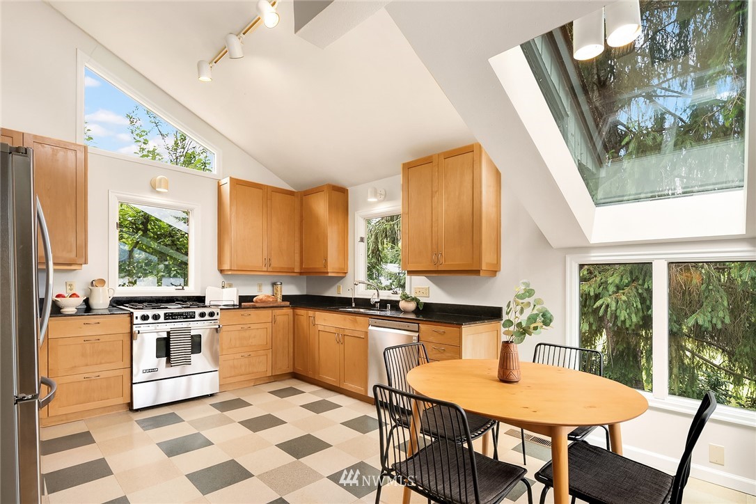 4730 Spring Street Bellingham, WA 98229 - Photo 9 of 30 a kitchen with stainless steel appliances granite countertop a stove a sink and a microwave