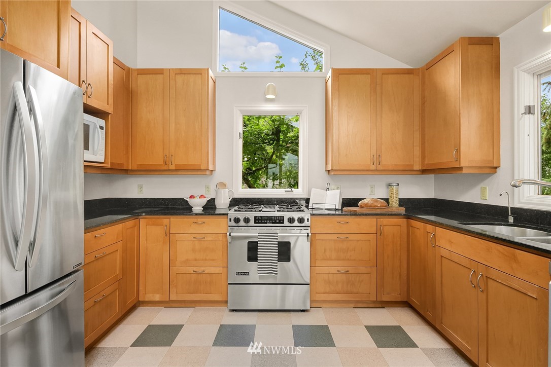 4730 Spring Street Bellingham, WA 98229 - Photo 10 of 30 a kitchen with stainless steel appliances granite countertop a stove a sink and a refrigerator