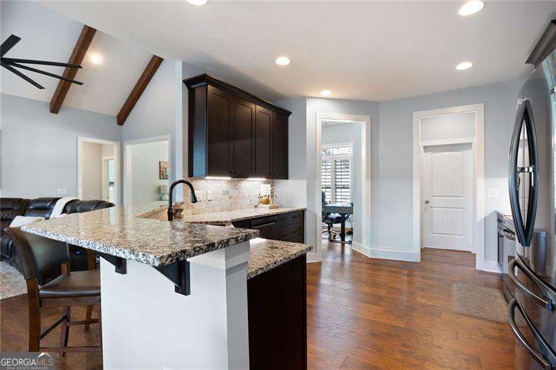 61 Roberson Drive White, GA 30184 - Photo 21 of 46 a kitchen with stainless steel appliances granite countertop a sink a stove and a refrigerator