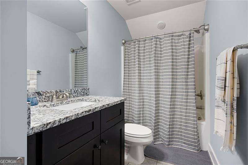 61 Roberson Drive White, GA 30184 - Photo 31 of 46 a bathroom with a granite countertop toilet sink and mirror