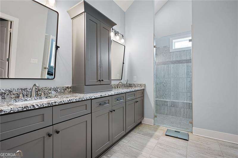 61 Roberson Drive White, GA 30184 - Photo 34 of 46 a bathroom with double sink and a mirror