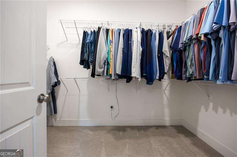 61 Roberson Drive White, GA 30184 - Photo 37 of 46 a view of walk in closet with clothes