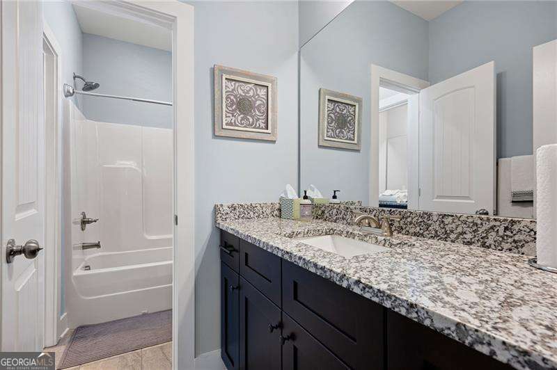 61 Roberson Drive White, GA 30184 - Photo 39 of 46 a bathroom with a granite countertop tub sink and mirror