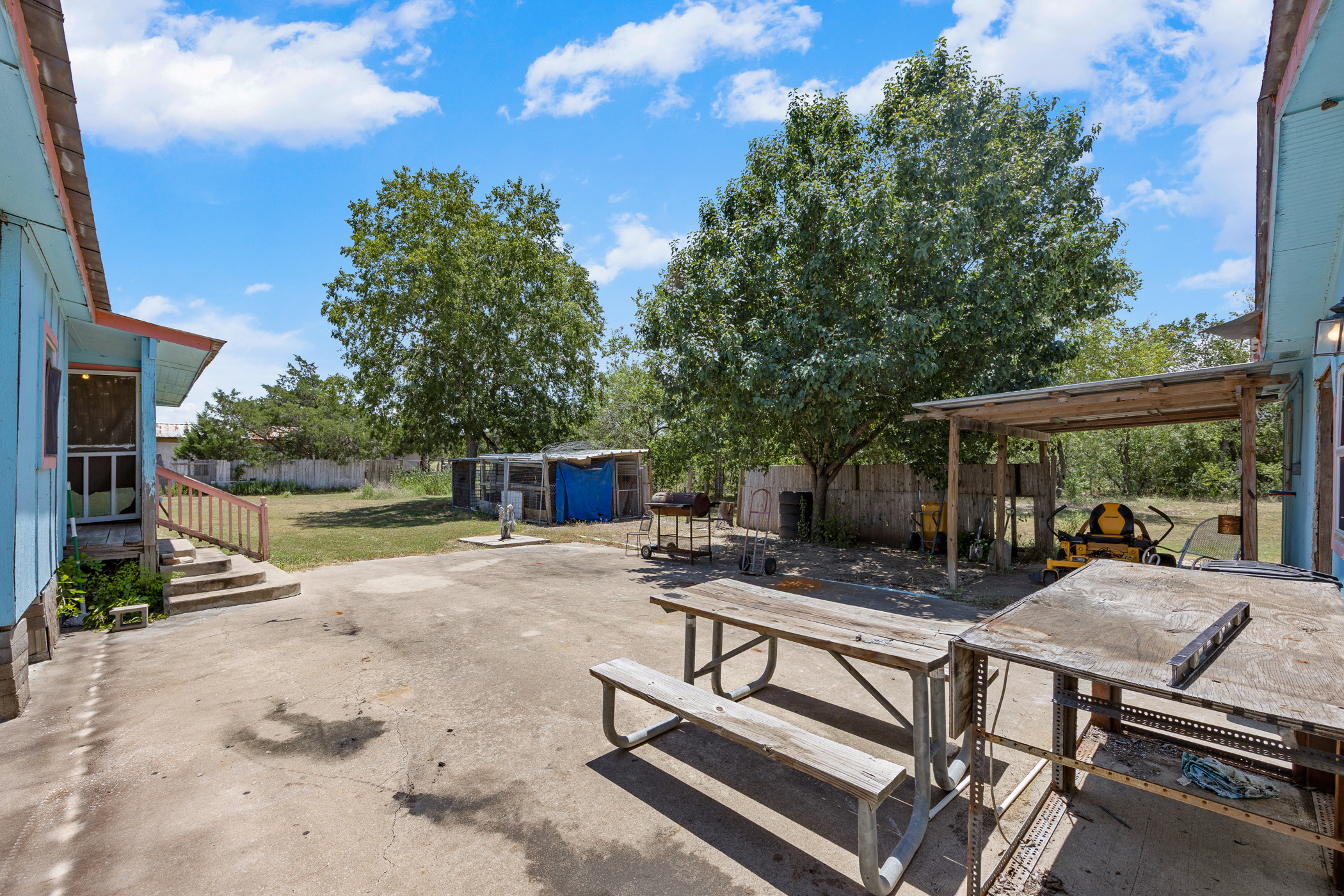 147 Community Center Road Rosanky, TX 78953 - Photo 22 of 33 Fenced backyard featuring a patio area, outdoor dining area, and a shed