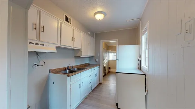 a kitchen with a sink and cabinets