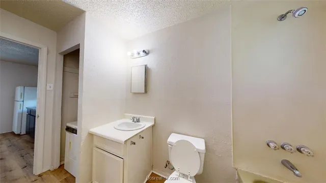 a white toilet sitting next to a bathroom sink