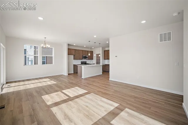 a view of a kitchen with a sink and dishwasher wooden floor