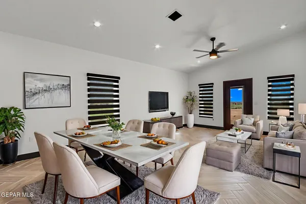 a living room with furniture a flat screen tv and a table