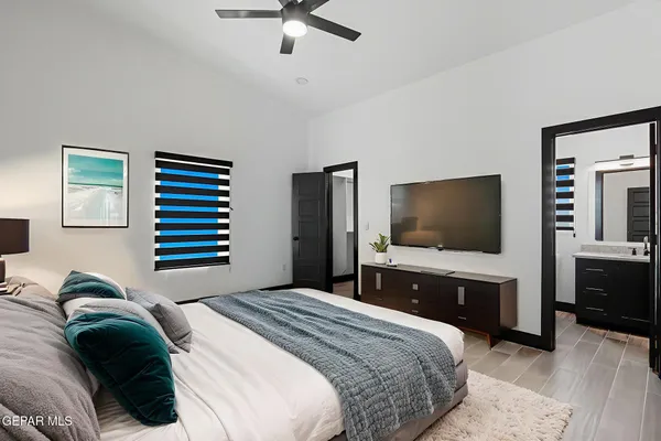 a bedroom with a bed and a flat screen tv