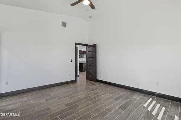 a view of an empty room with wooden floor