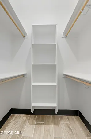 a view of walk in closet with empty racks