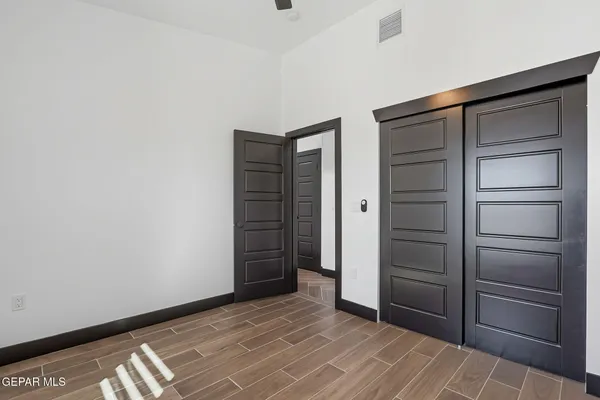 a view of walk in closet with empty racks