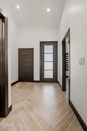a view of an empty room with closet and utility room