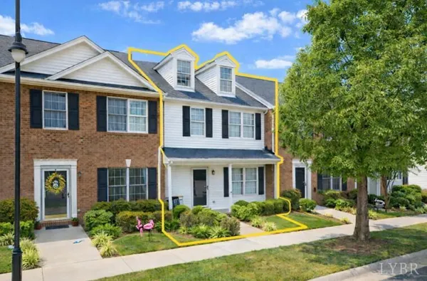 front view of a brick house with a yard