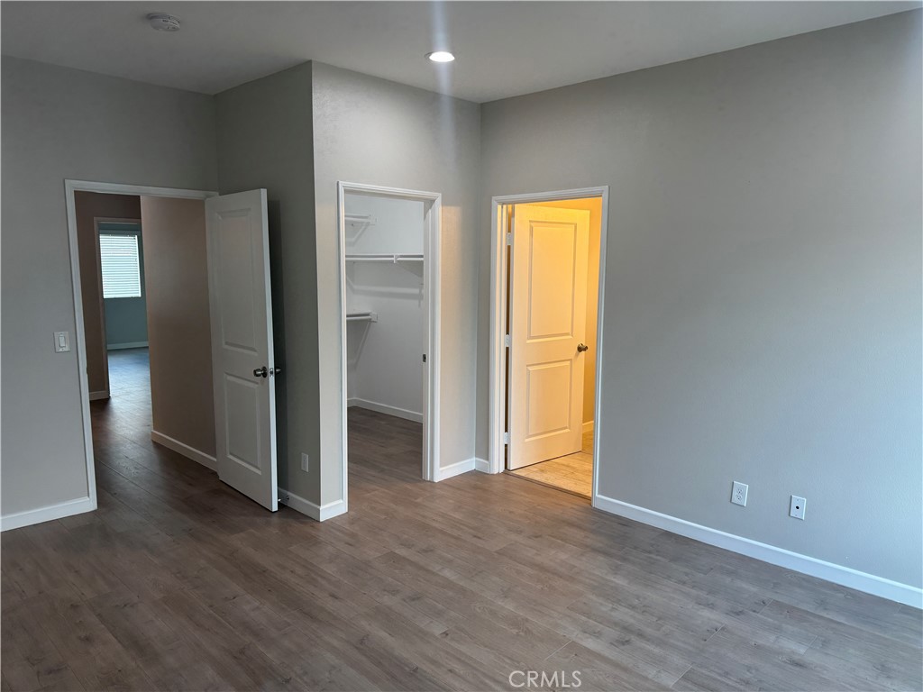13665 Arrow Route, Unit 3 Fontana, CA 92335 - Photo 23 of 32 a view of empty room with wooden floor and window
