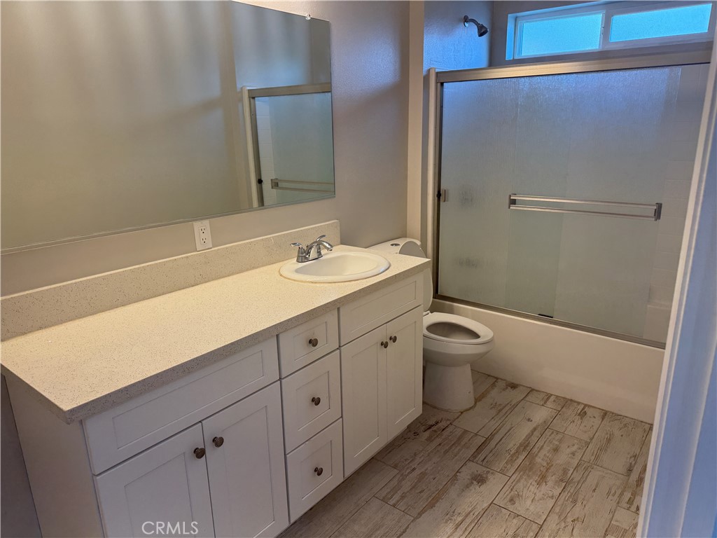13665 Arrow Route, Unit 3 Fontana, CA 92335 - Photo 25 of 32 a bathroom with a double vanity sink toilet and shower