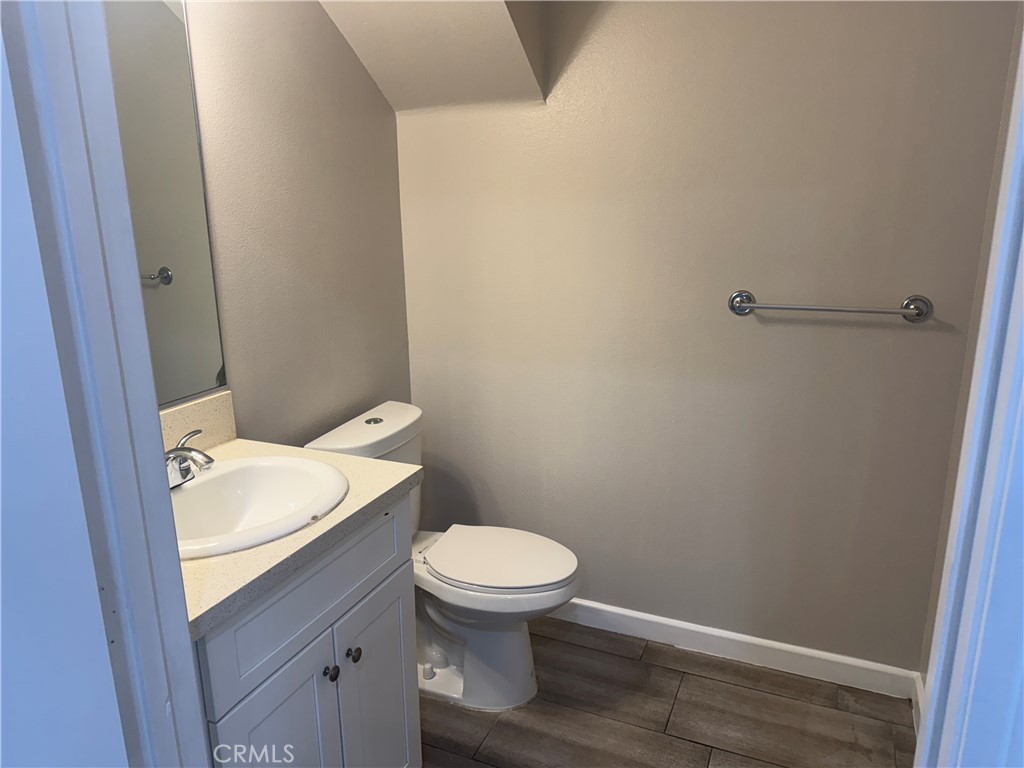 13665 Arrow Route, Unit 3 Fontana, CA 92335 - Photo 10 of 32 a white toilet sitting next to a bathroom sink