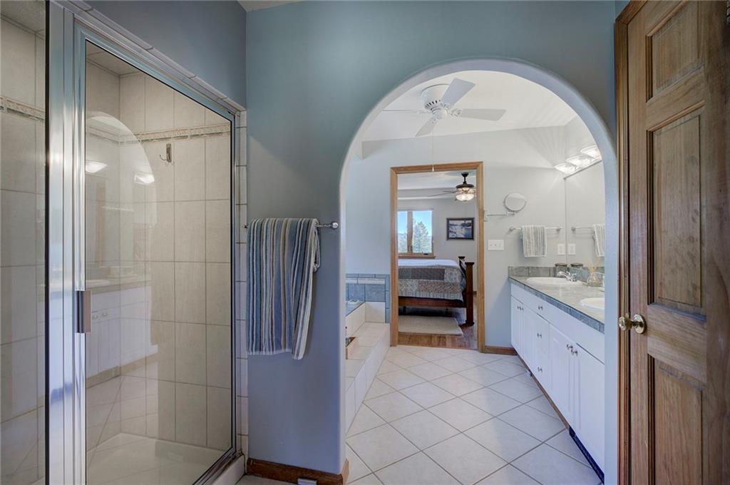 78 Double Tree Road Bailey, CO 80421 - Photo 19 of 34 a spacious bathroom with a walk in closet and a bathroom