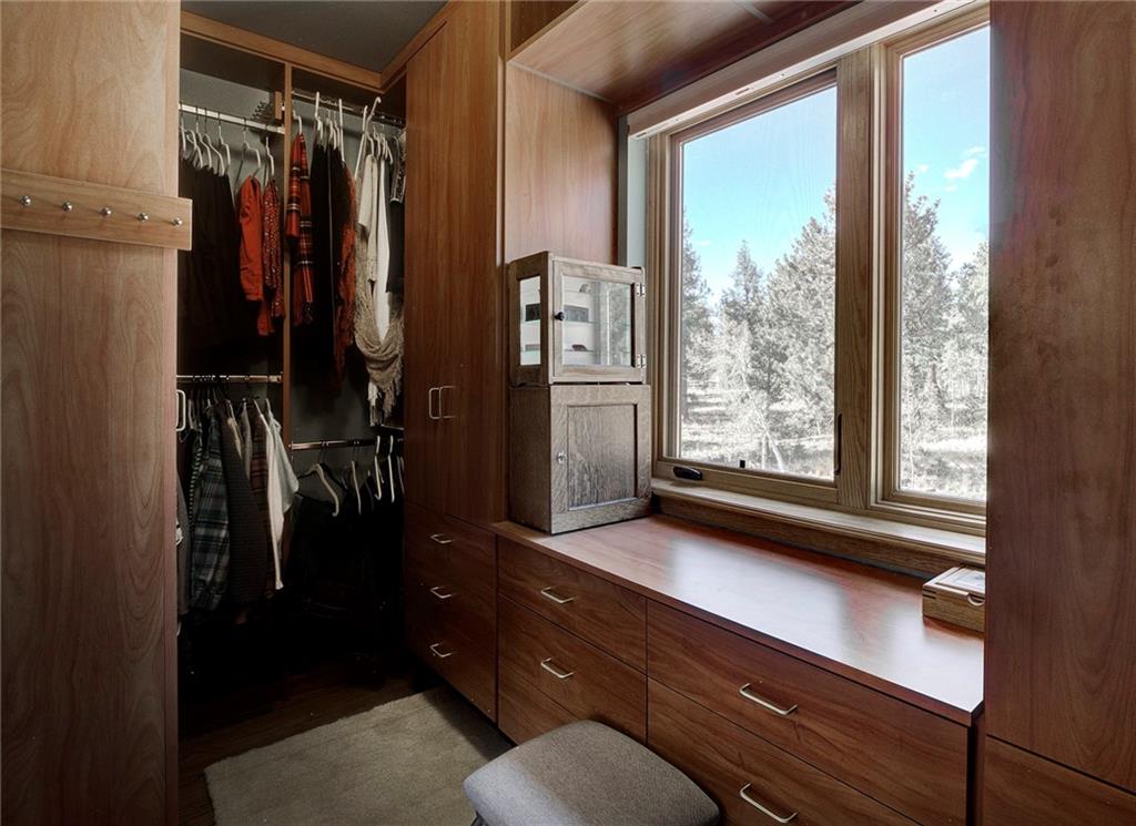 78 Double Tree Road Bailey, CO 80421 - Photo 20 of 34 a view of walk in closet with clothes and shoes