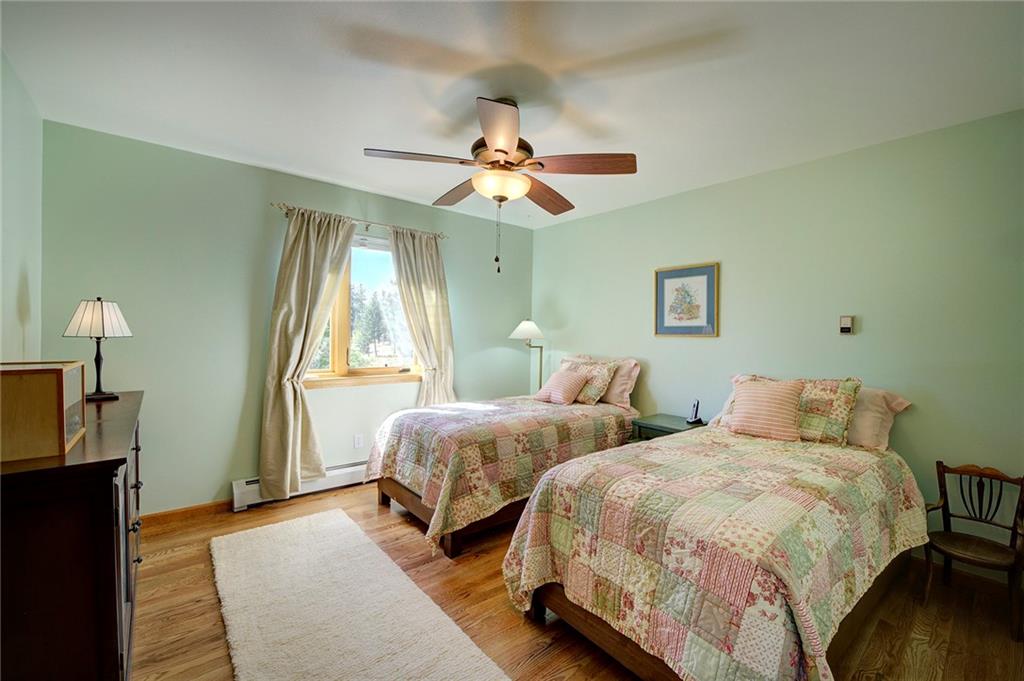 78 Double Tree Road Bailey, CO 80421 - Photo 21 of 34 a bedroom with two beds and a chandelier