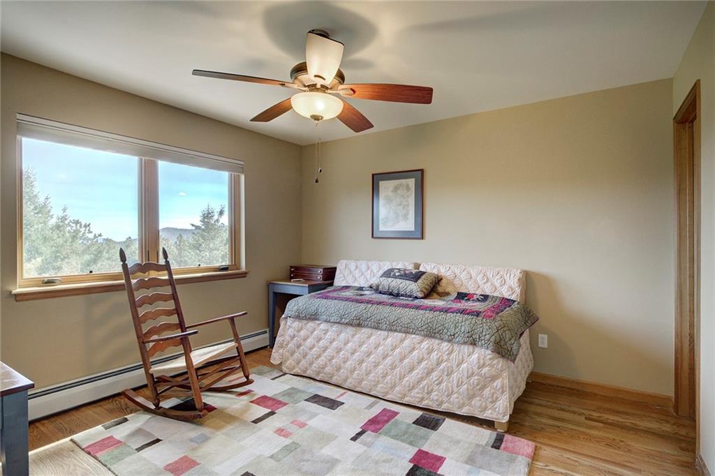 78 Double Tree Road Bailey, CO 80421 - Photo 22 of 34 a living room with a bed furniture and a window