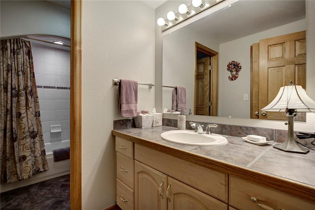 78 Double Tree Road Bailey, CO 80421 - Photo 28 of 34 a bathroom with a granite countertop sink and a mirror