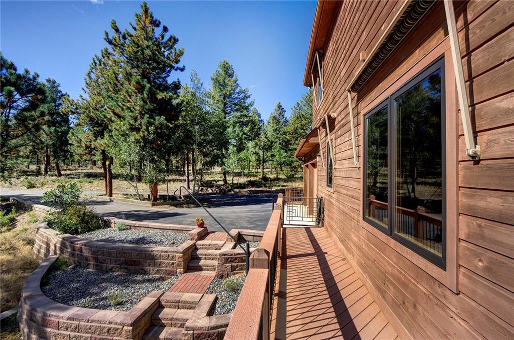 78 Double Tree Road Bailey, CO 80421 - Photo 4 of 34 a view of balcony with wooden floor and outdoor seating