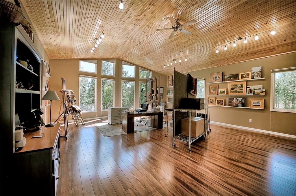 78 Double Tree Road Bailey, CO 80421 - Photo 31 of 34 a living room with furniture large window and wooden floor