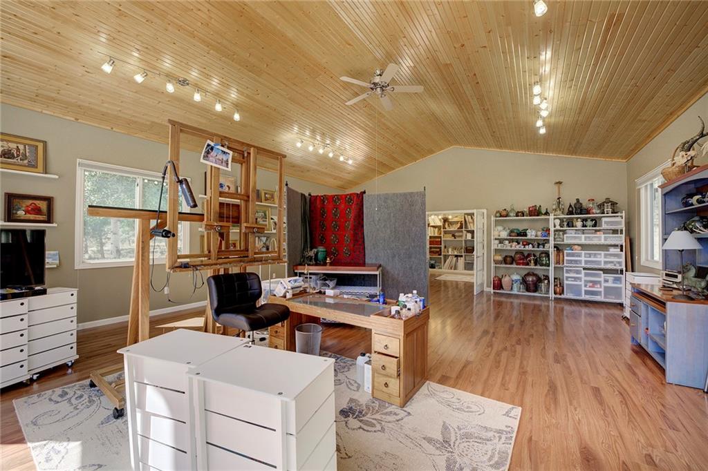 78 Double Tree Road Bailey, CO 80421 - Photo 32 of 34 a living room with fireplace furniture and a flat screen tv