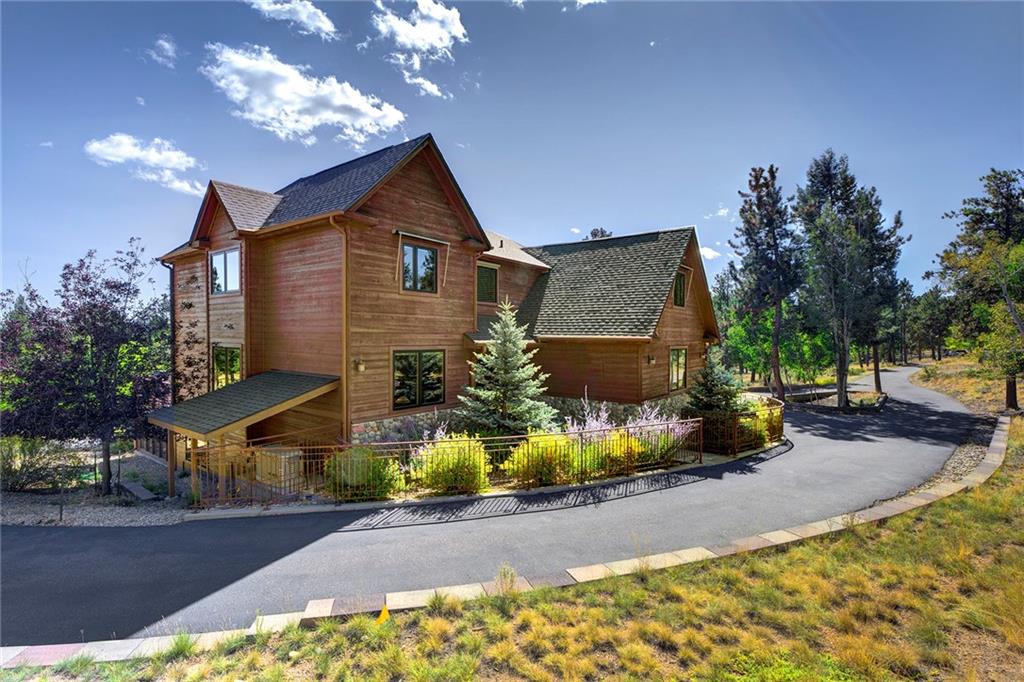 78 Double Tree Road Bailey, CO 80421 - Photo 5 of 34 a front view of a house with a yard and garage