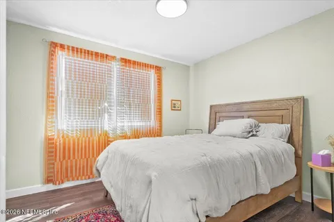 a bedroom with a bed and a large window