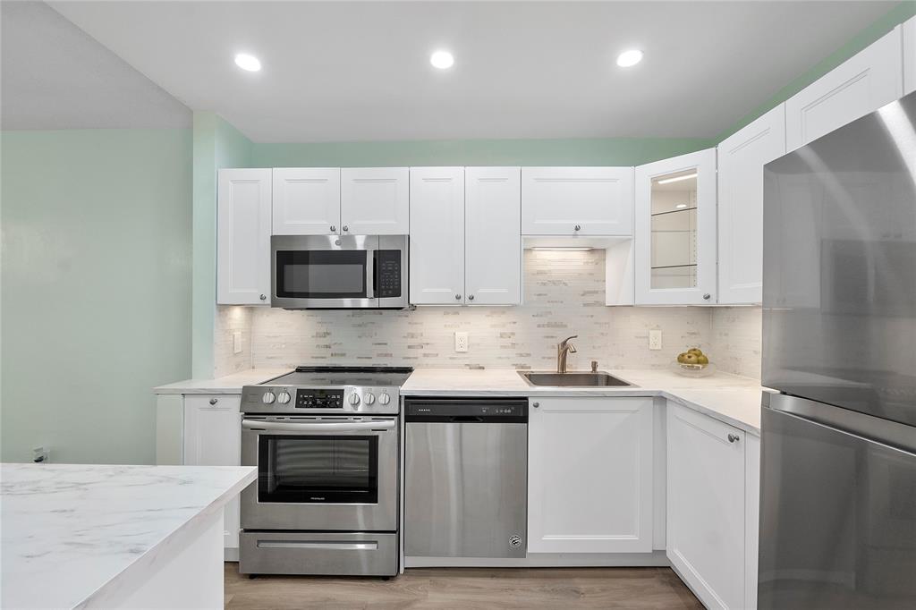 1951 Northeast 39th Street, Unit 156 Lighthouse Point, FL 33064 - Photo 3 of 43 View of the kitchen from the main entrance