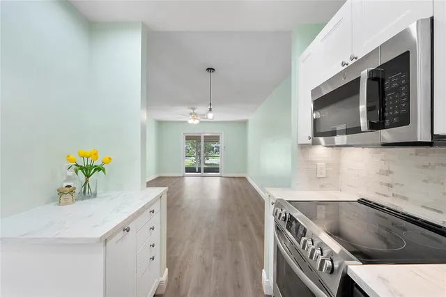a kitchen with counter top space cabinets and microwave
