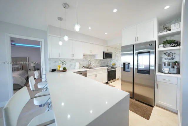 a kitchen with refrigerator and cabinets