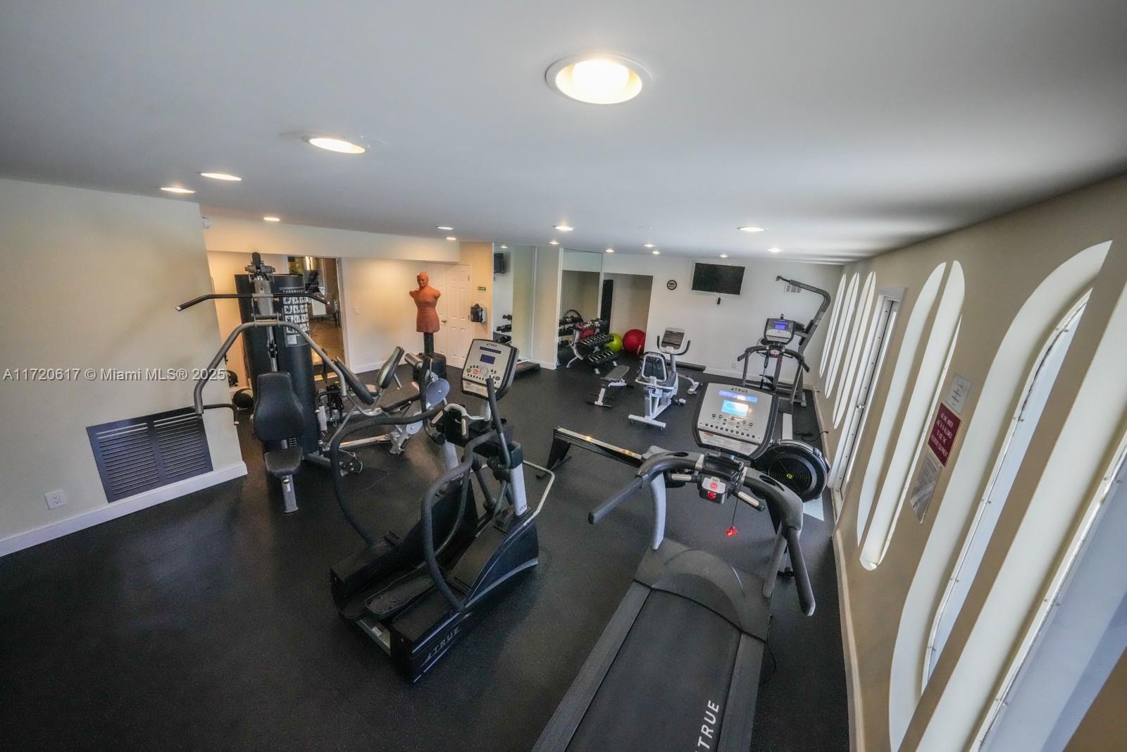 200 Diplomat Parkway, Unit 827 Hallandale Beach, FL 33009 - Photo 18 of 26 a view of a room with gym equipment