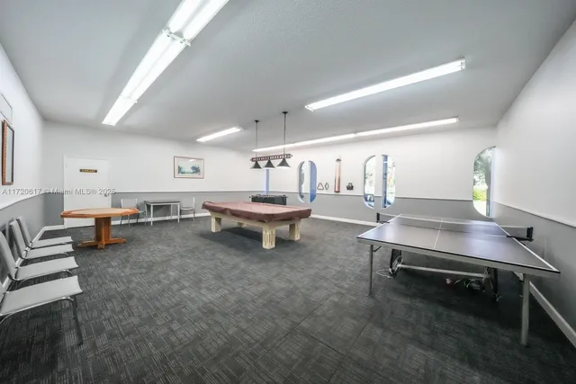 a living room with furniture and large windows