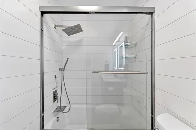 a view of a patio with table and chairs under an umbrella