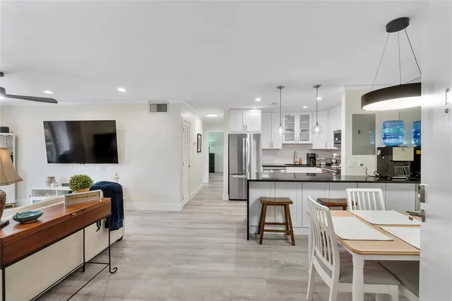 a kitchen with stainless steel appliances granite countertop a refrigerator stove microwave and sink