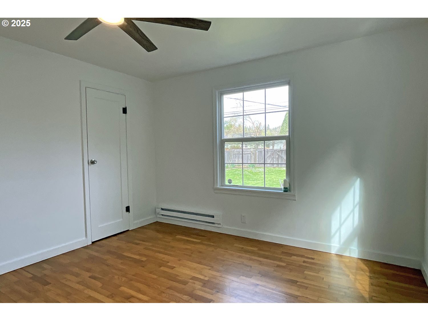 2775 Hilyard Street Eugene, OR 97405 - Photo 11 of 27 a view of an empty room with wooden floor and a window
