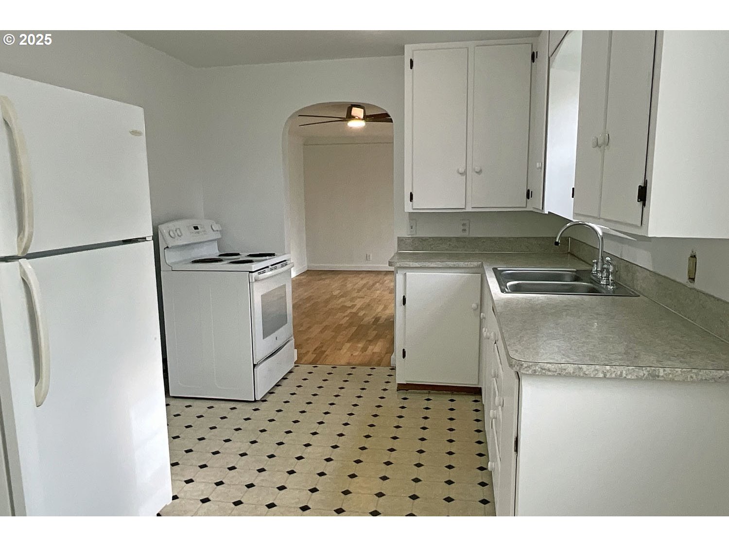 2775 Hilyard Street Eugene, OR 97405 - Photo 4 of 27 a kitchen with a sink a refrigerator and a stove
