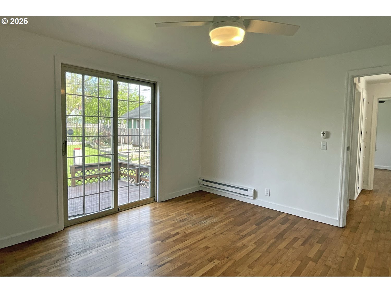2775 Hilyard Street Eugene, OR 97405 - Photo 9 of 27 a view of an empty room with wooden floor and a window