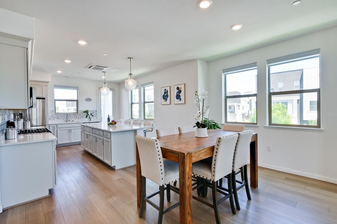 6656 Stealth Loop San Jose, CA 95119 - Photo 16 of 50 a view of a dining room with furniture and wooden floor