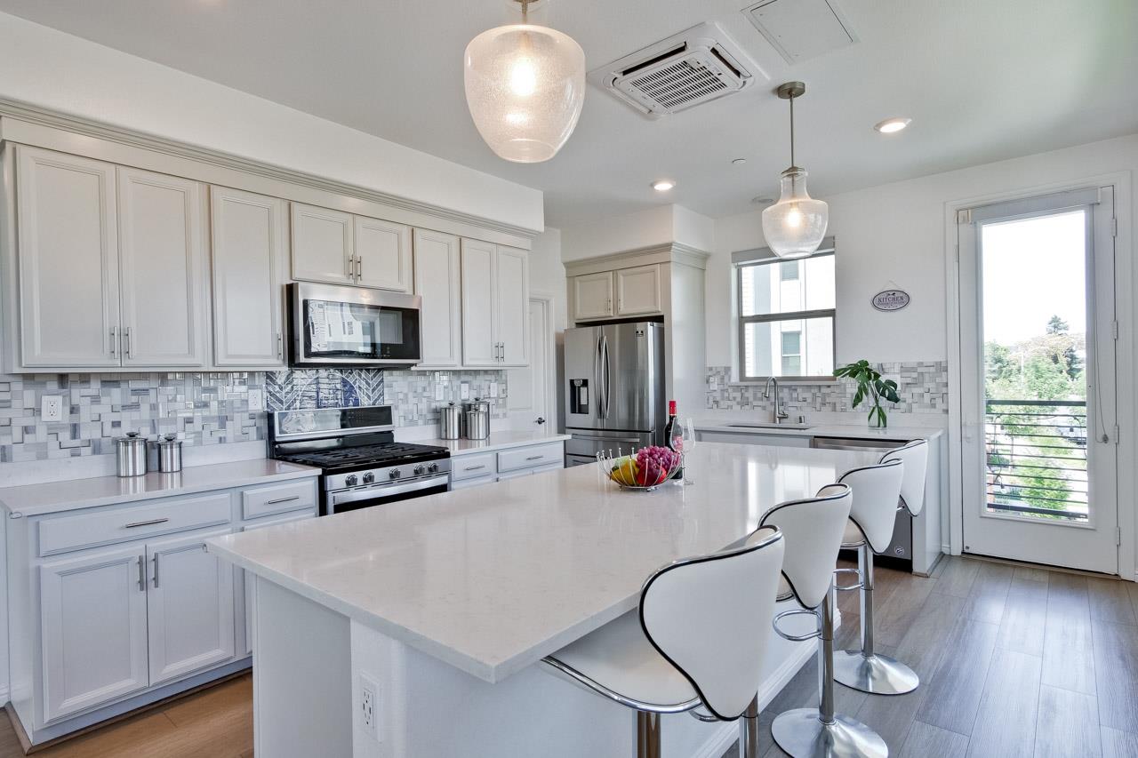 6656 Stealth Loop San Jose, CA 95119 - Photo 22 of 50 a kitchen with sink a microwave and cabinets
