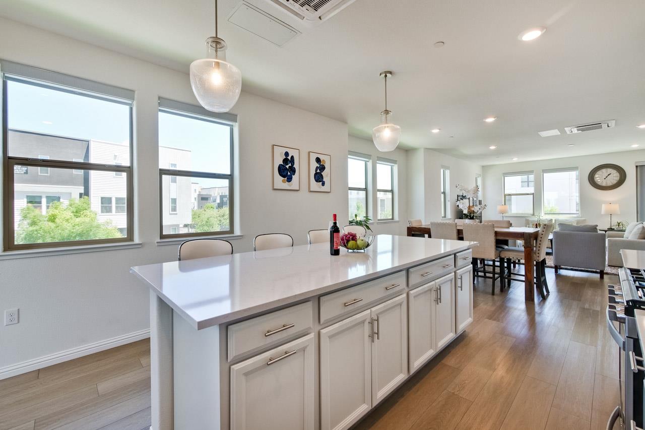 6656 Stealth Loop San Jose, CA 95119 - Photo 23 of 50 a kitchen with stainless steel appliances granite countertop sink stove dining table and chairs