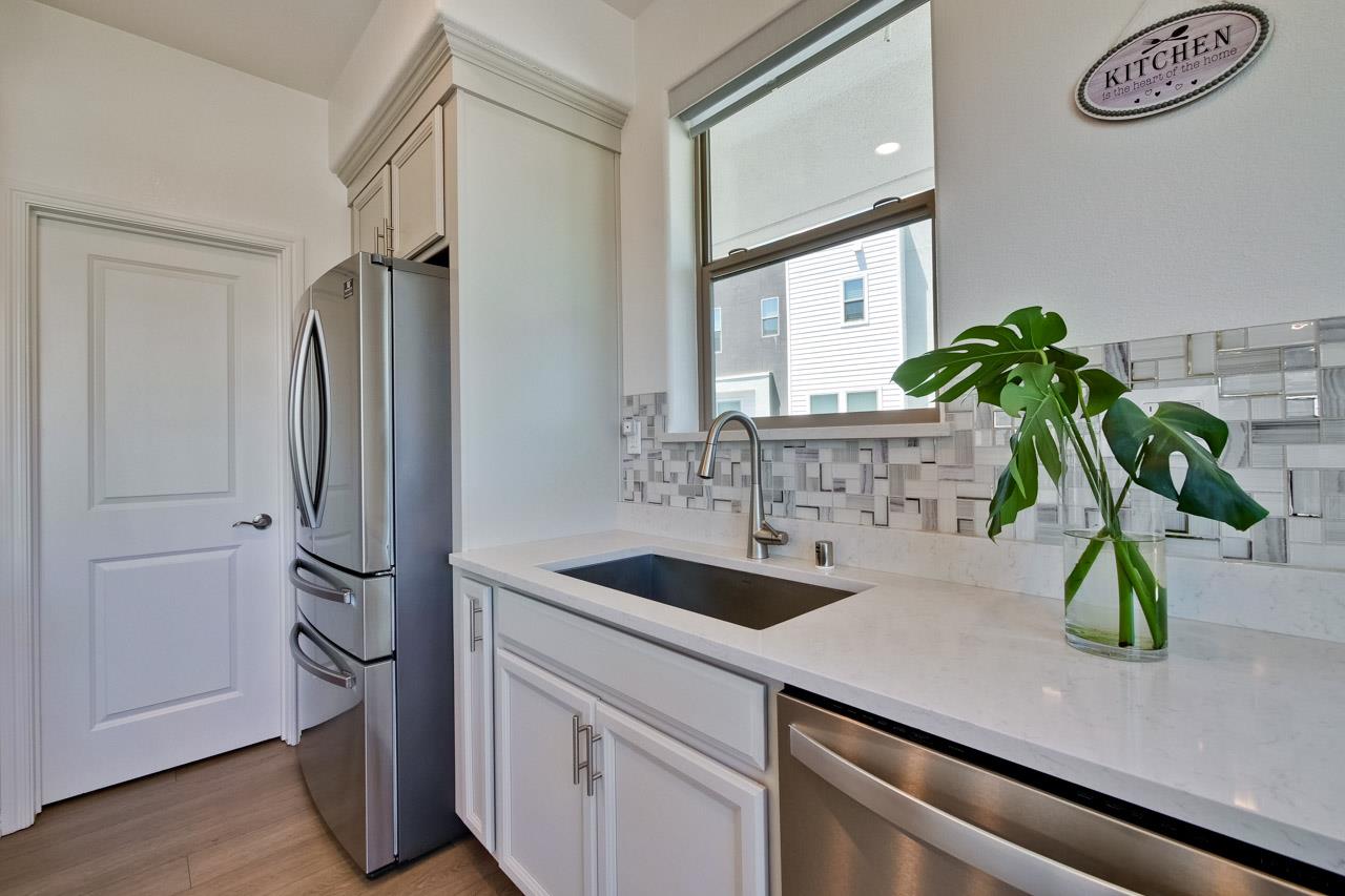 6656 Stealth Loop San Jose, CA 95119 - Photo 24 of 50 a bathroom with a sink a mirror and a potted plant