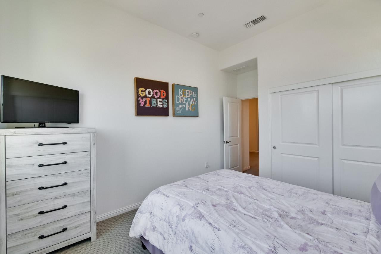 6656 Stealth Loop San Jose, CA 95119 - Photo 29 of 50 a bedroom with a bed and a flat screen tv