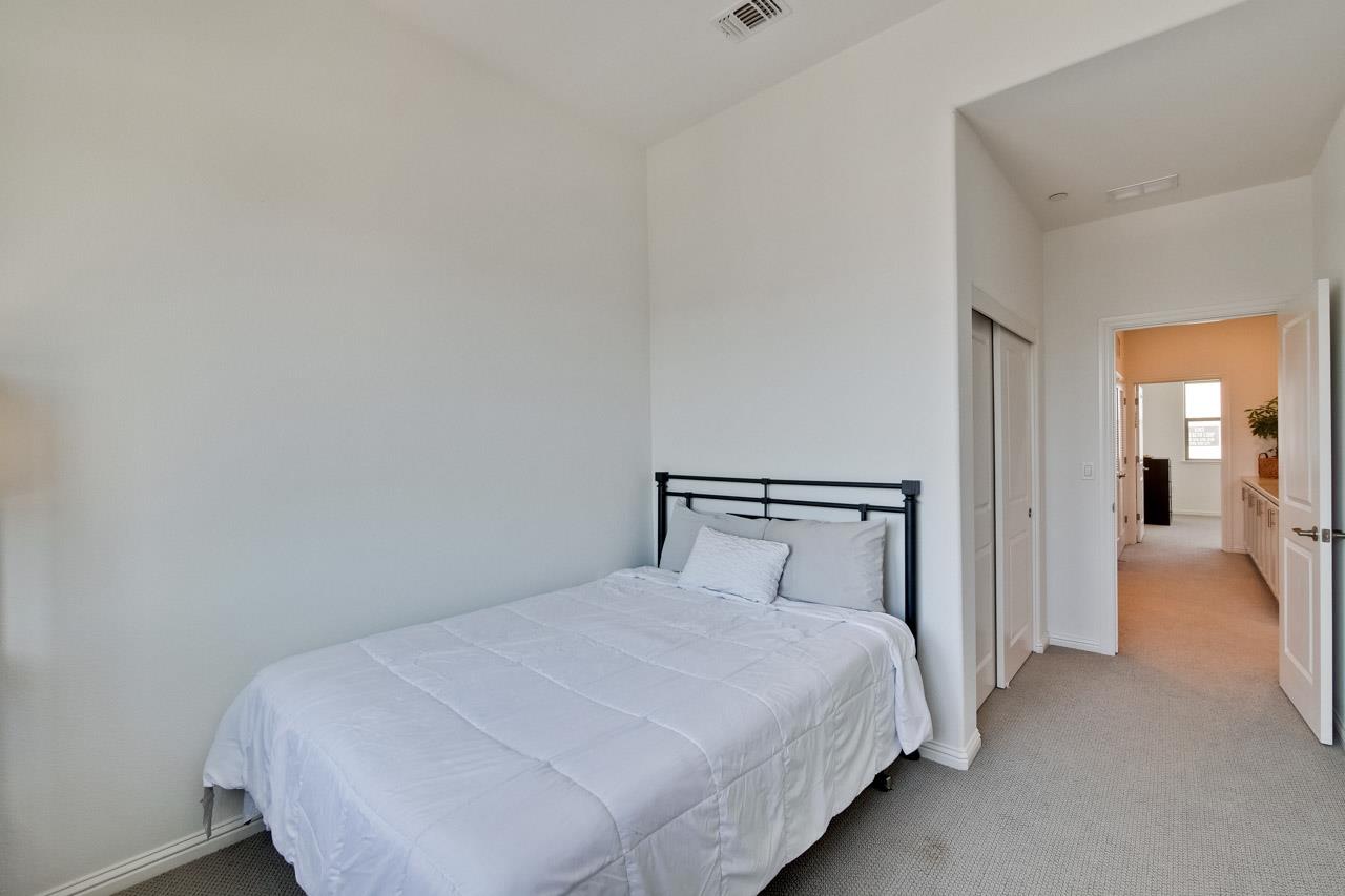 6656 Stealth Loop San Jose, CA 95119 - Photo 32 of 50 a bedroom with a bed and closet