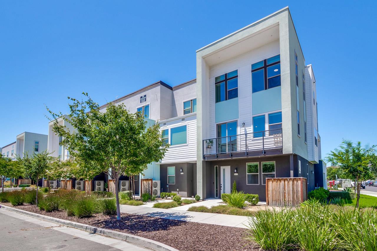 6656 Stealth Loop San Jose, CA 95119 - Photo 4 of 50 a front view of a building with garden and trees