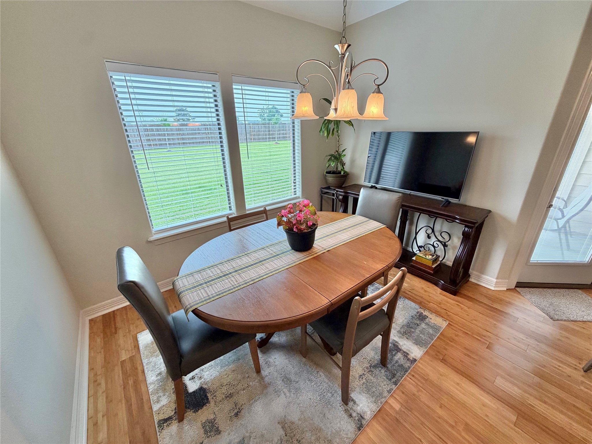 1448 South Blue Bonnet Lane Angleton, TX 77515 - Photo 15 of 43 a dining room with furniture and wooden floor