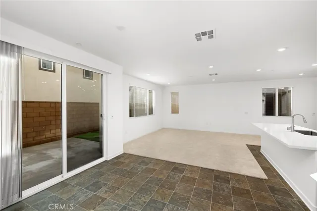 a view of a kitchen with a sink and a large window